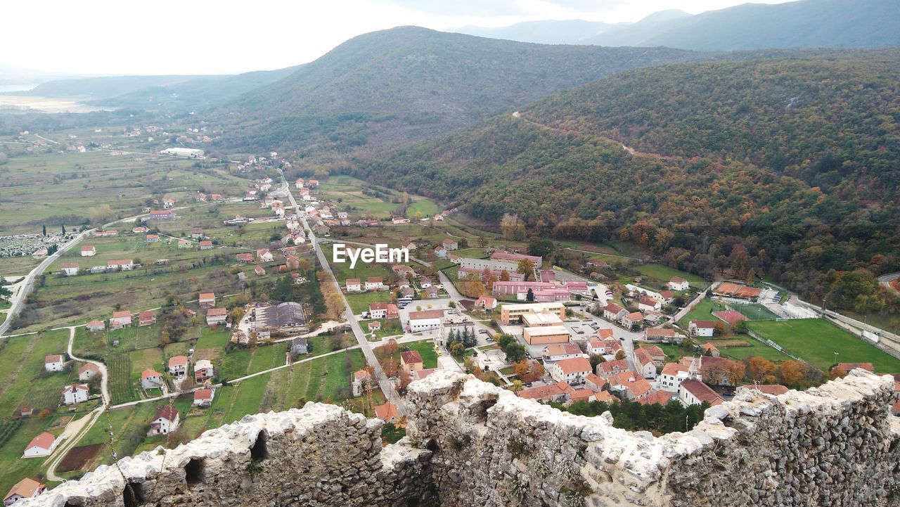 HIGH ANGLE VIEW OF TOWNSCAPE AND MOUNTAIN