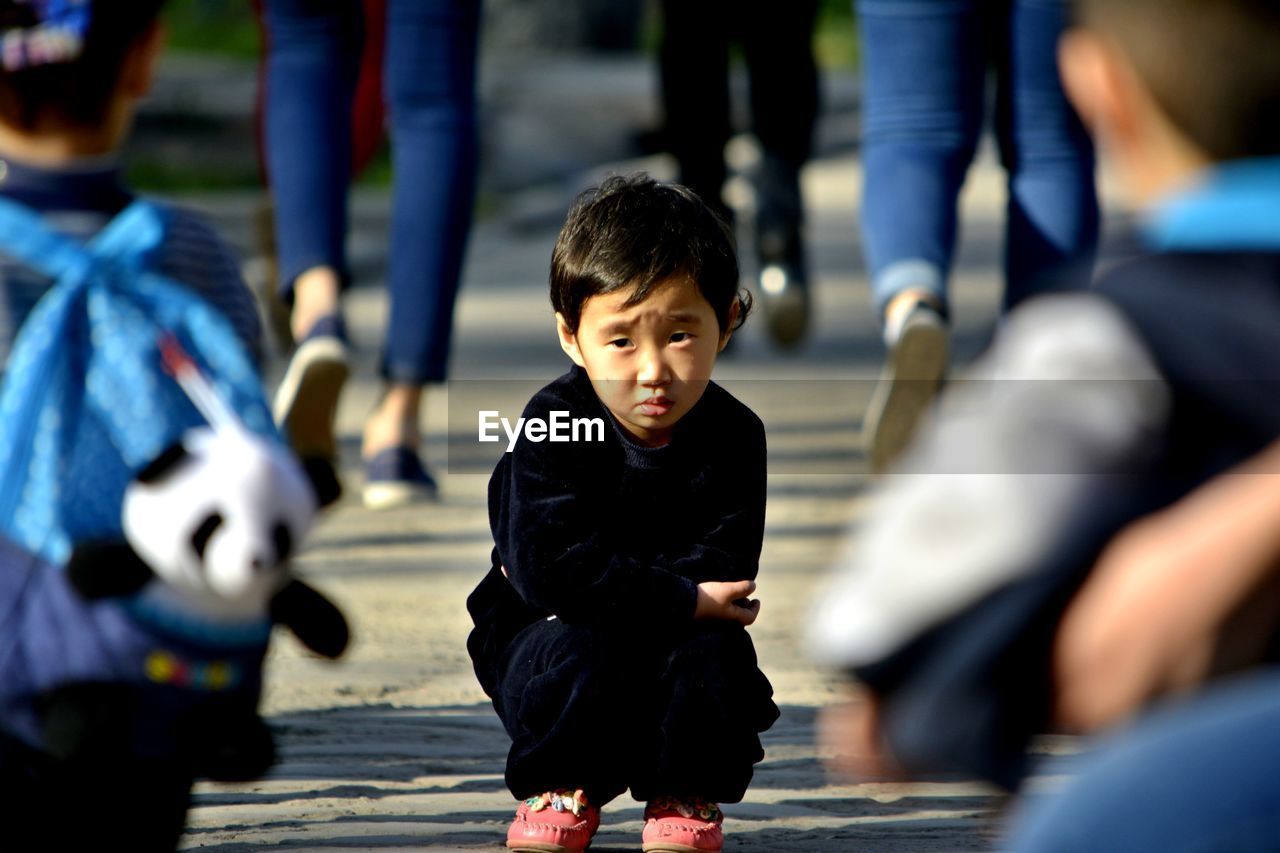 BOY PLAYING AT CAMERA