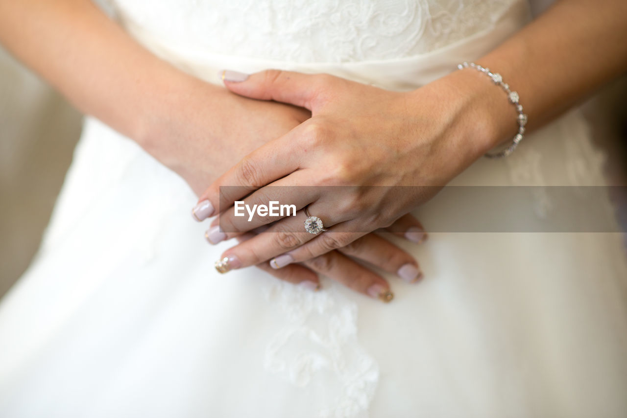 Midsection of bride wearing wedding ring