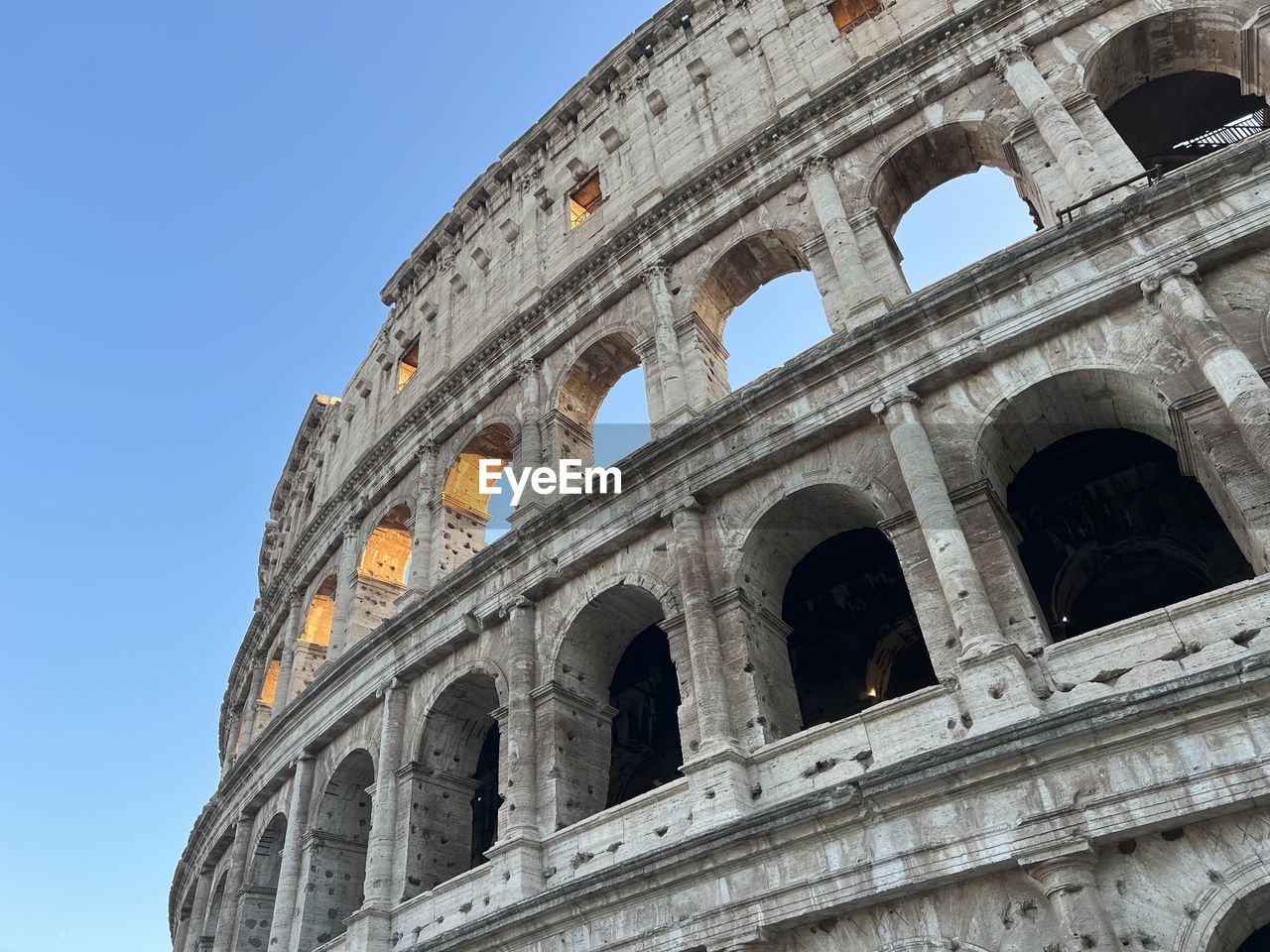 architecture, built structure, history, the past, landmark, low angle view, sky, building exterior, travel destinations, travel, city, tourism, no people, nature, clear sky, stadium, day, blue, ancient, outdoors