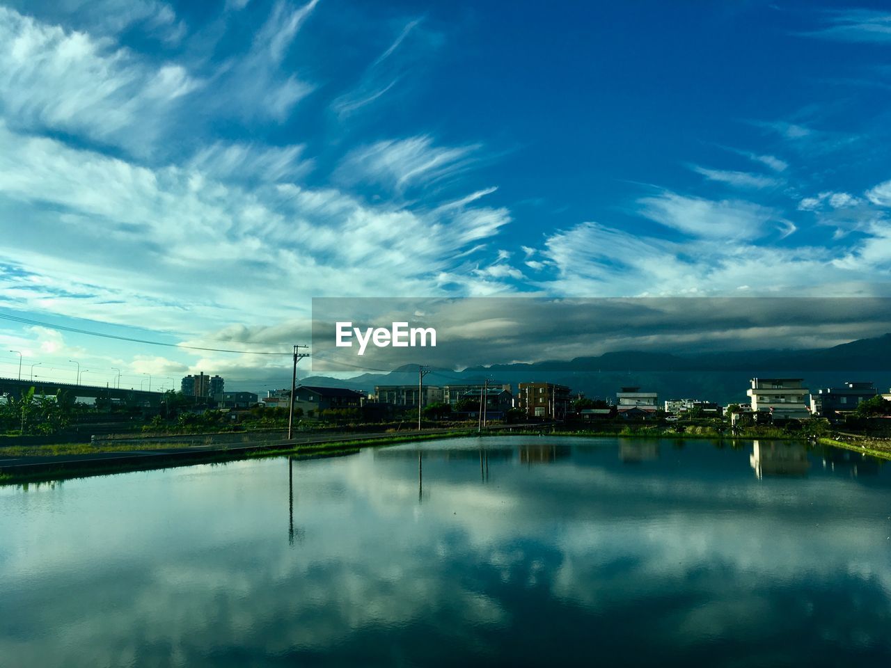 SCENIC VIEW OF CALM LAKE AGAINST SKY