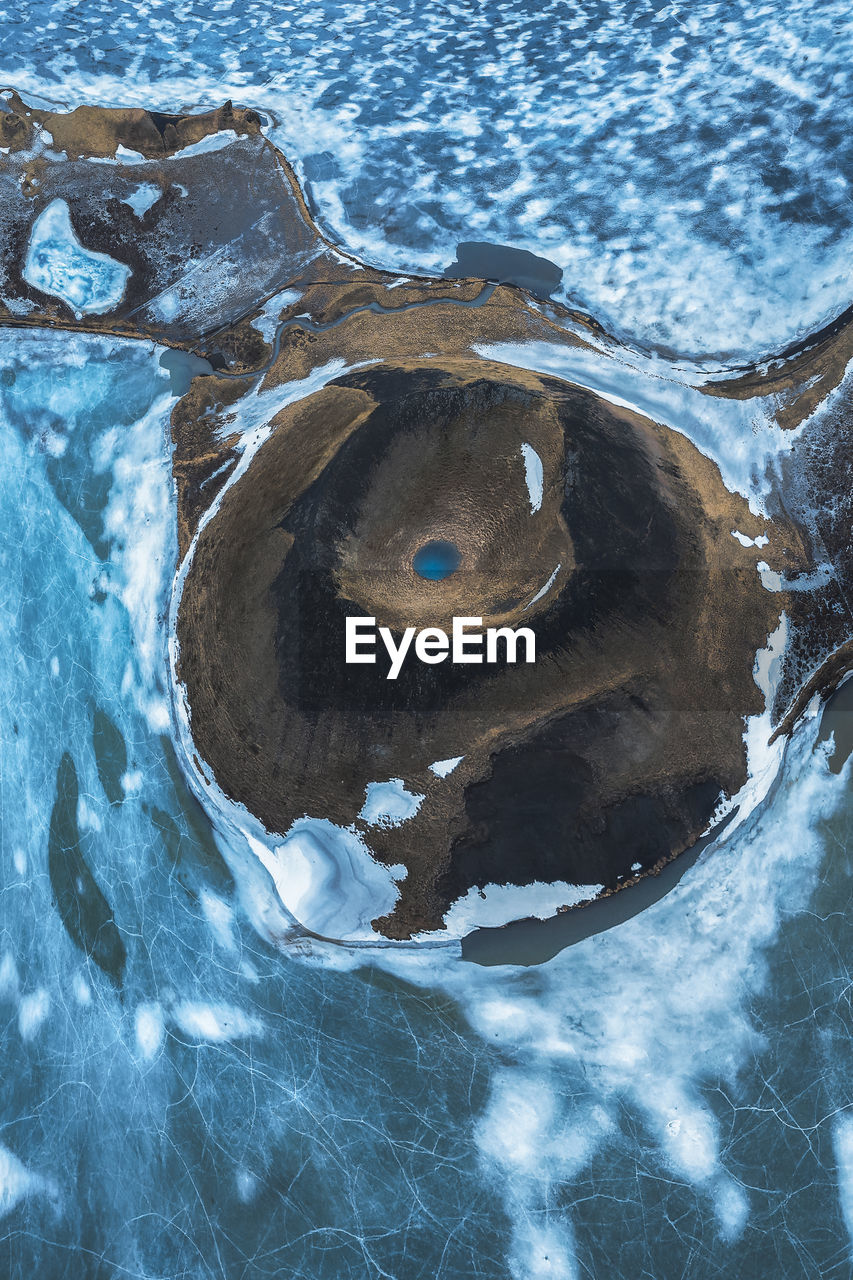 Top view picturesque drone view of skutustadagigar pseudocraters covered with snow located on shore of lake myvatn in cloudy winter day in iceland