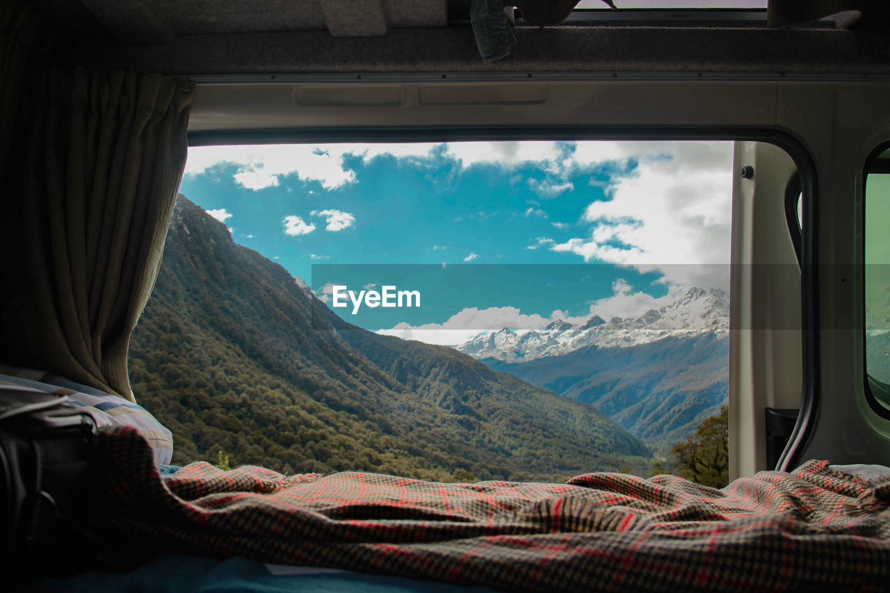 Scenic view of mountains seen through window