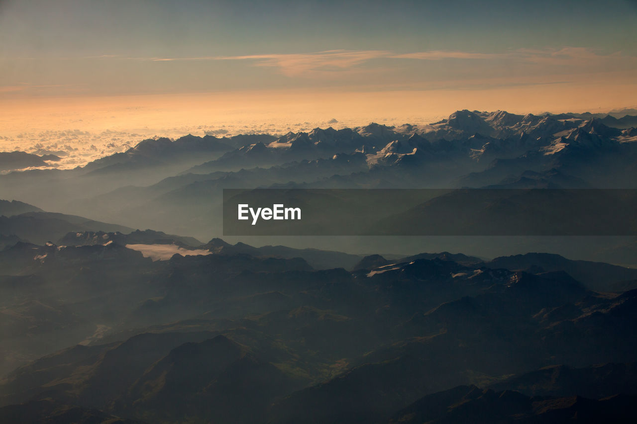 Scenic view of mountains against sky during sunset