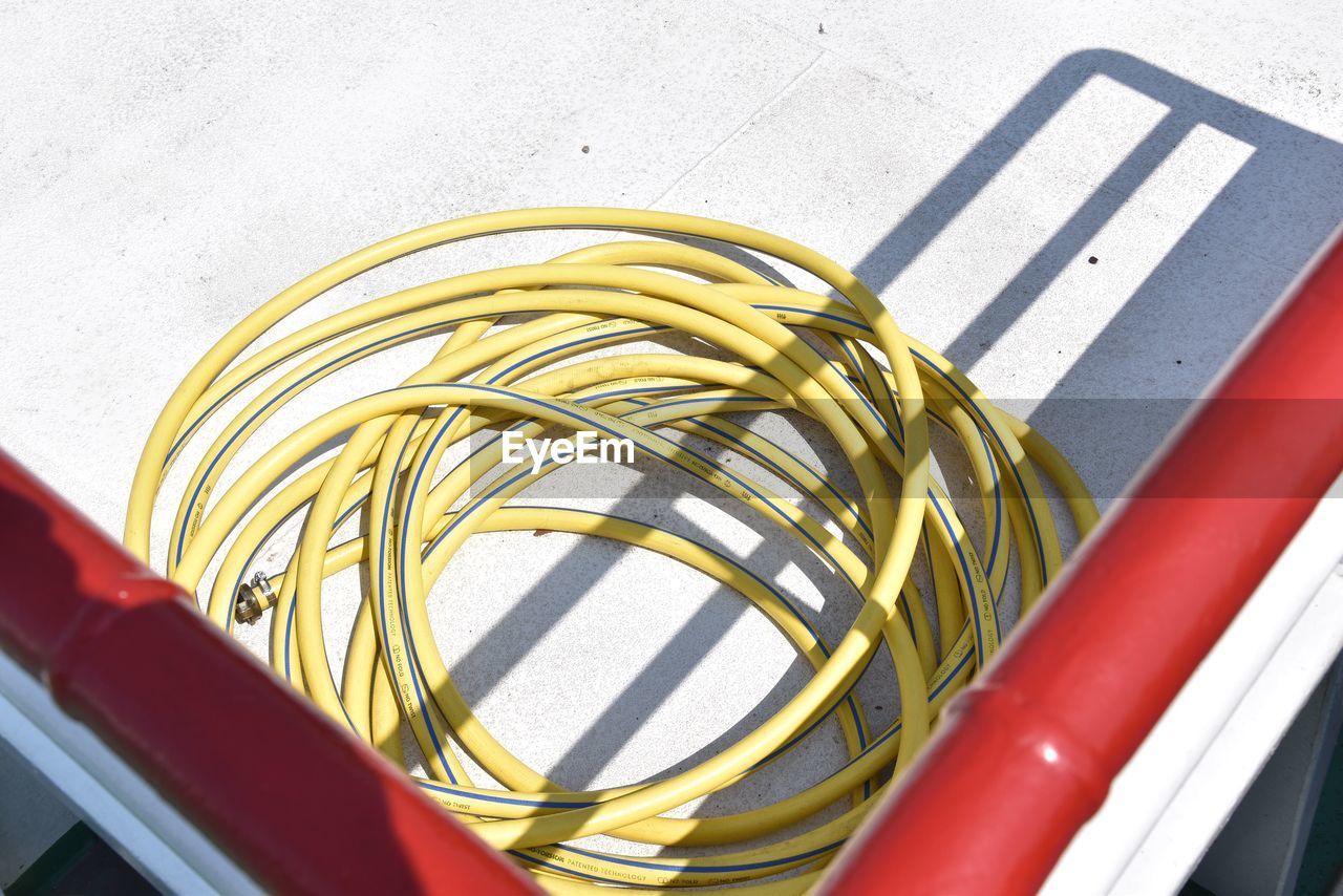 High angle view of garden hose on building terrace