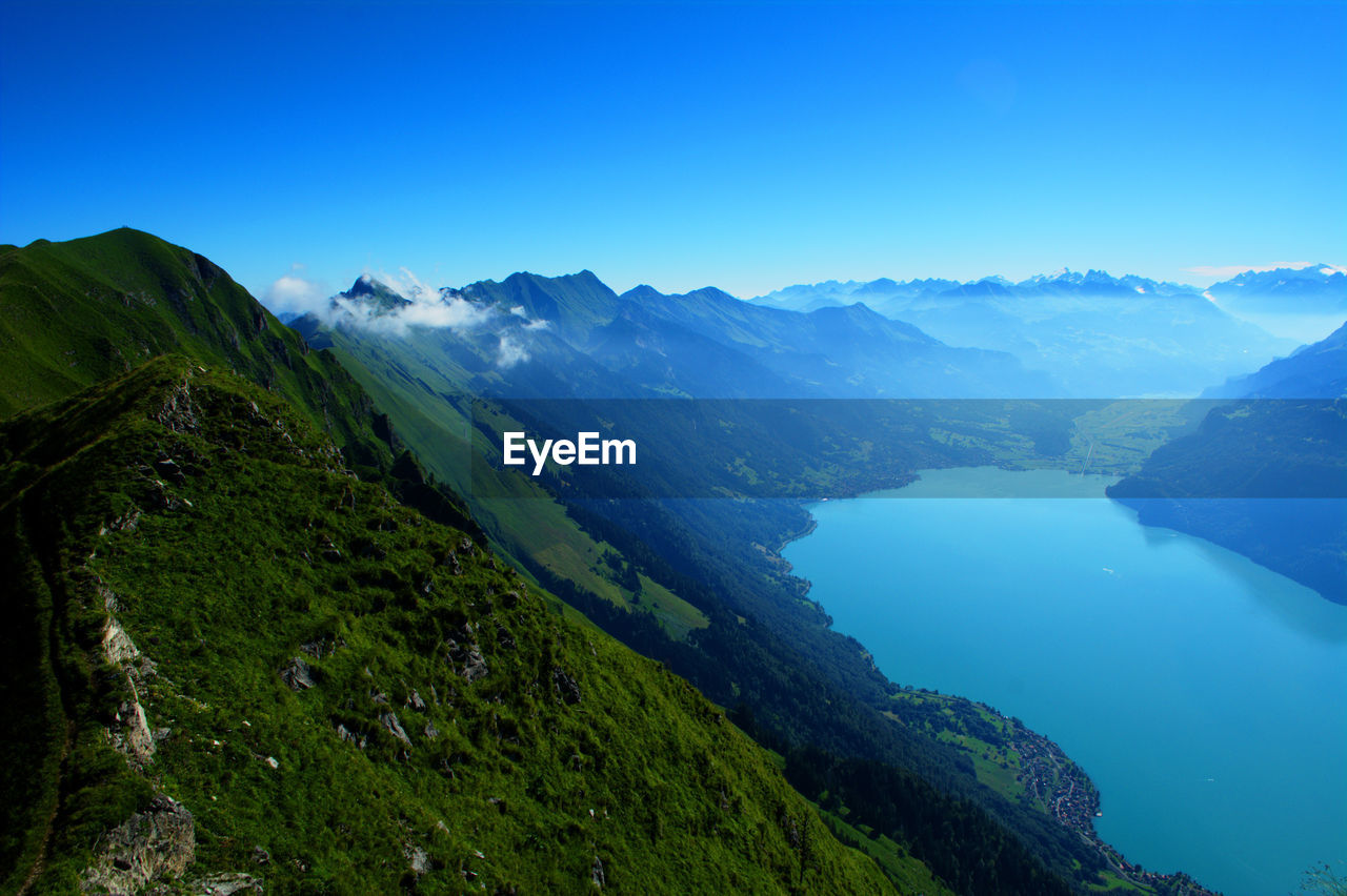 Scenic view of mountains against clear blue sky