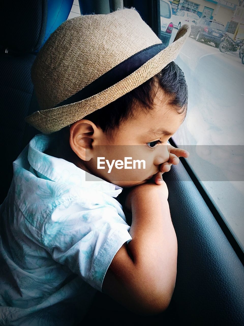 Close-up of boy looking through car window