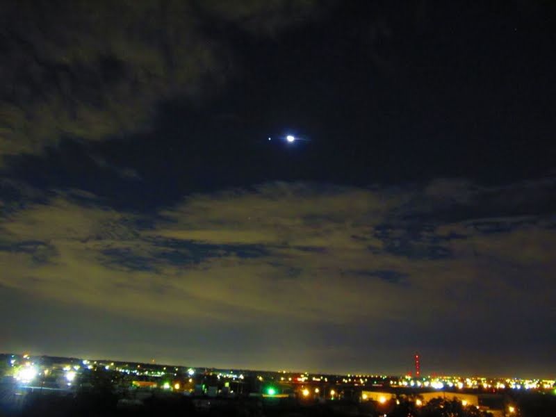 VIEW OF ILLUMINATED CITYSCAPE AT NIGHT