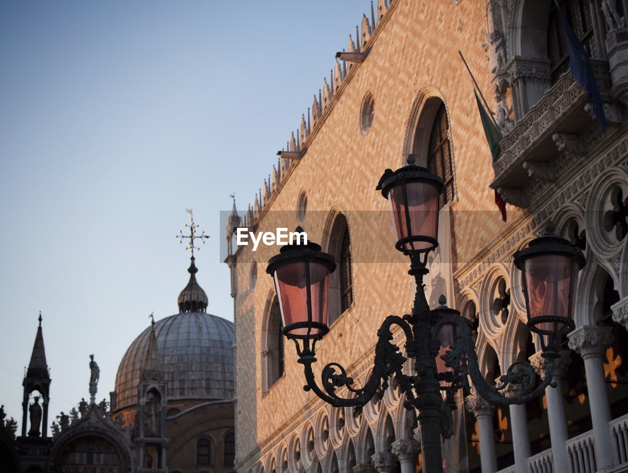 Low angle view of street light against buildings