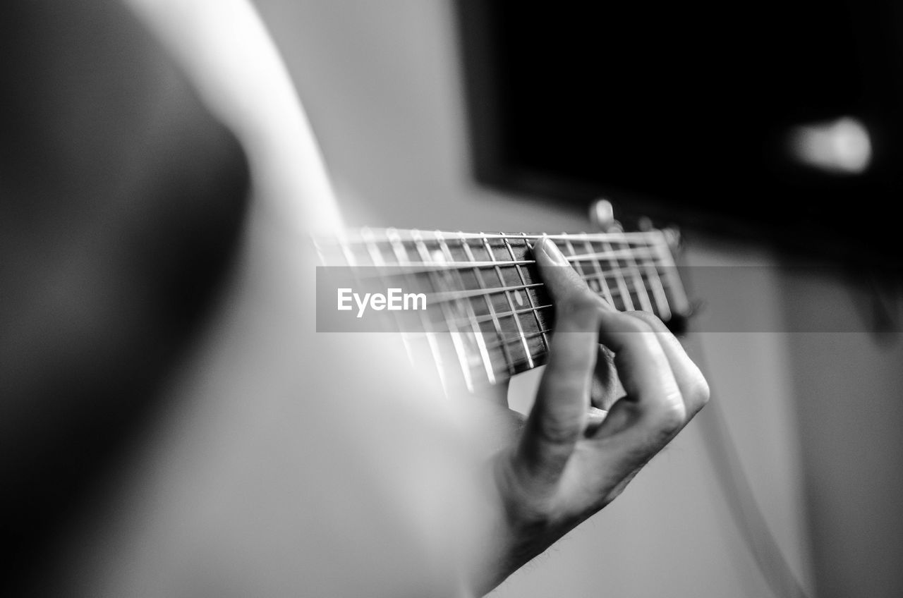 Cropped image of woman playing guitar