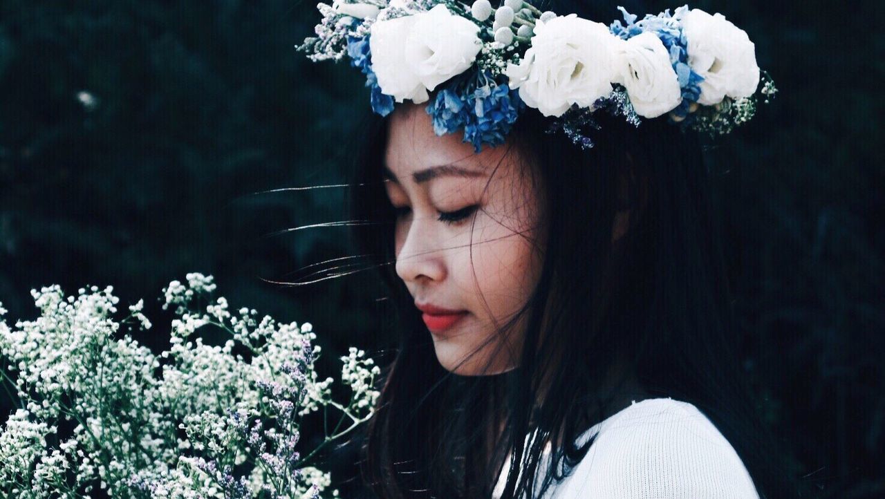 Close-up of woman holding flowers