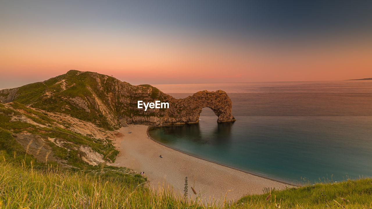 Scenic view of sea against sky during sunset at durdle door in dorset