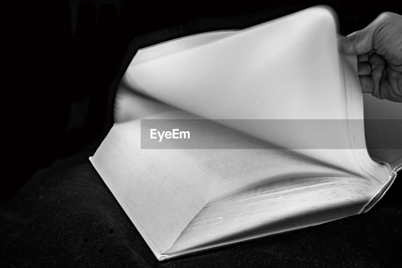 Cropped image of person turning bible page