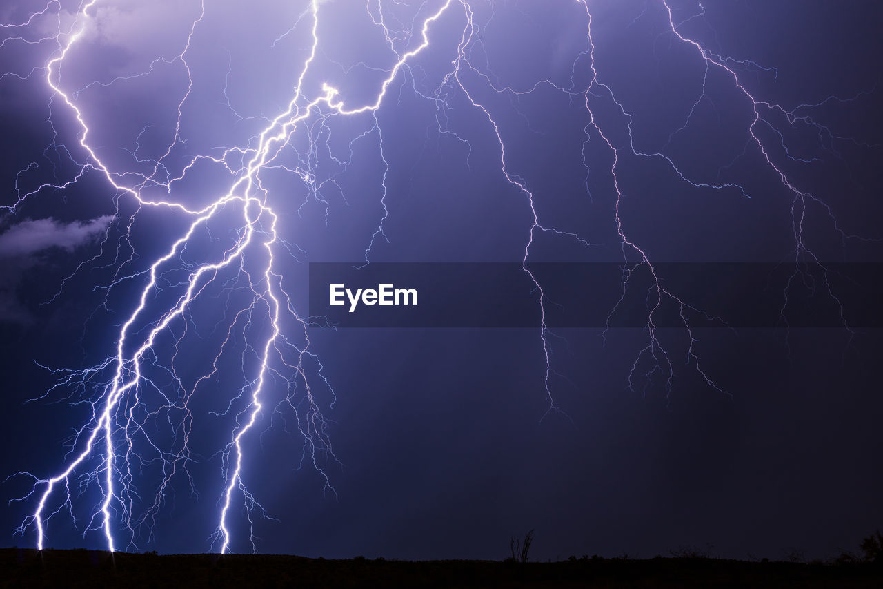 Dramatic lightning bolts strike from a monsoon thunderstorm near phoenix, arizona.