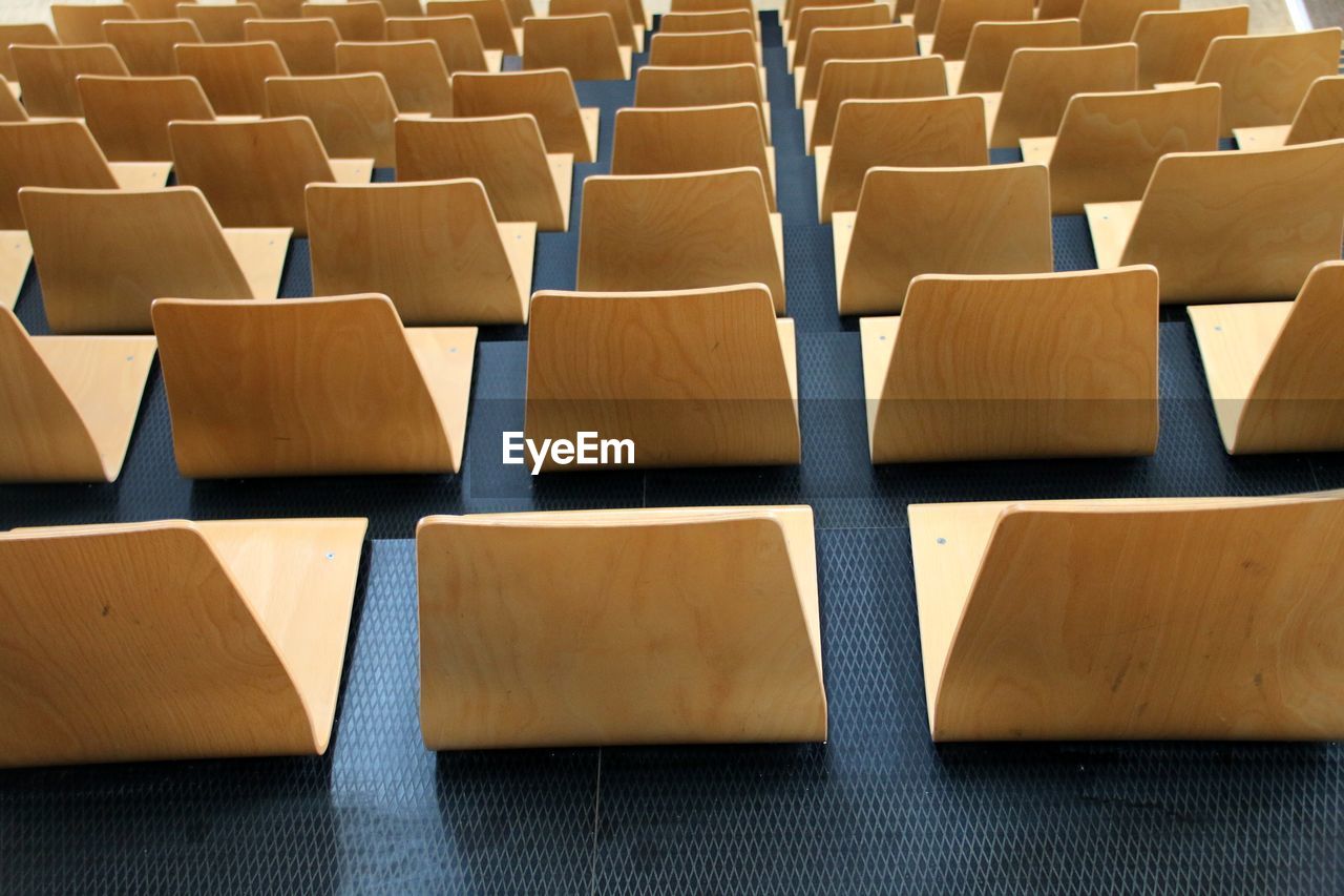 High angle view of wooden chairs at stadium