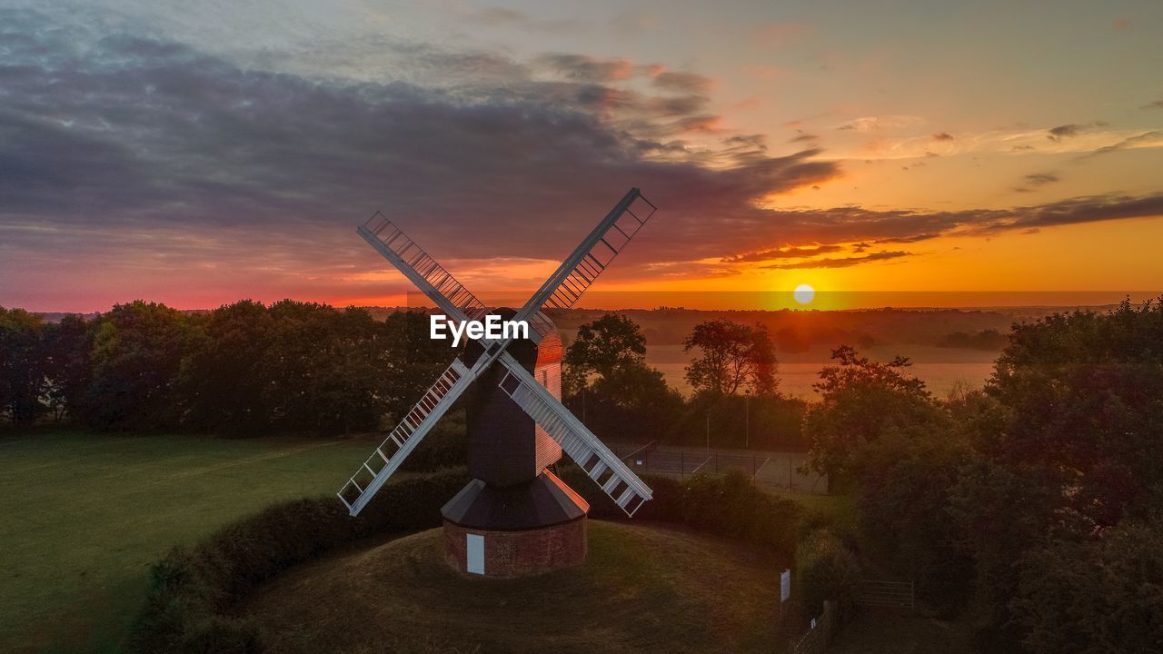 TRADITIONAL WINDMILL ON FIELD DURING SUNSET