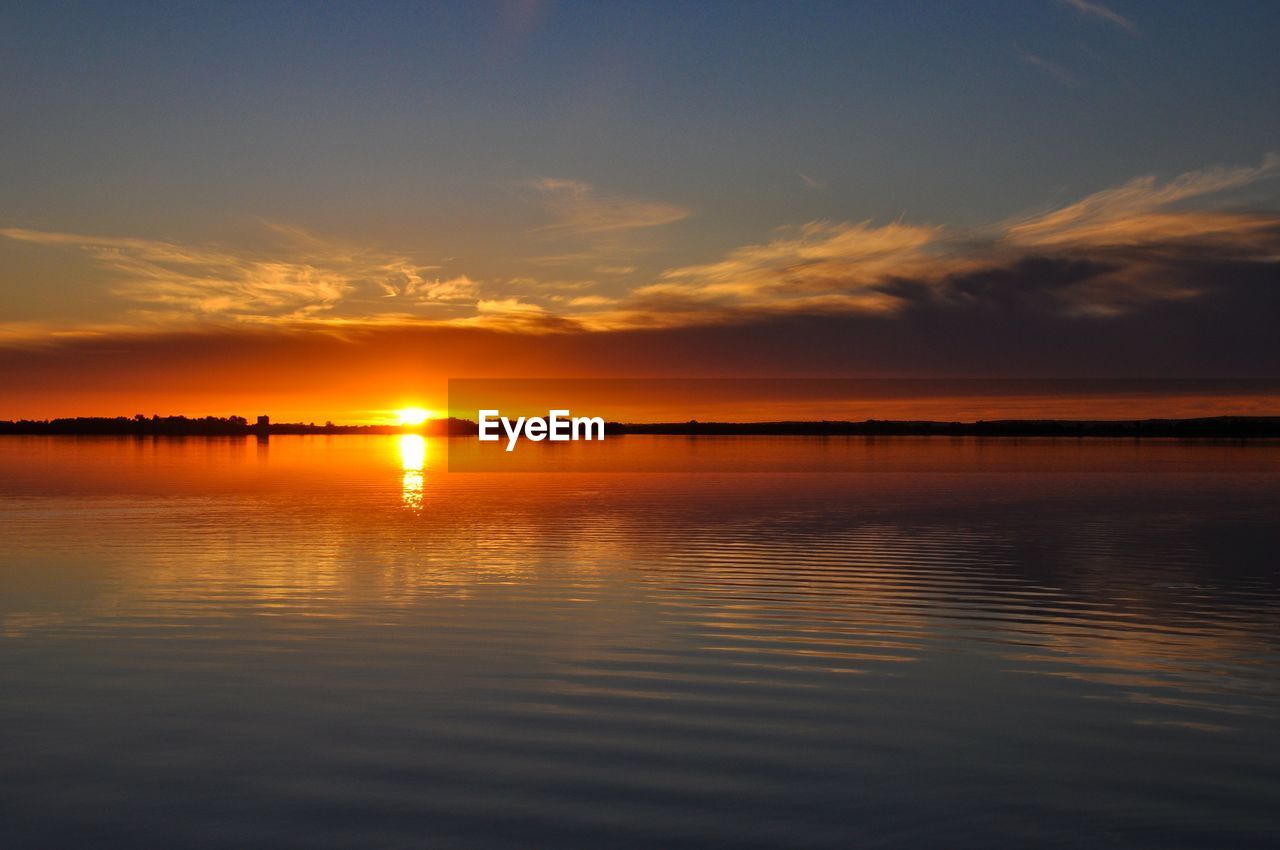 Scenic view of sea against romantic sky at sunset