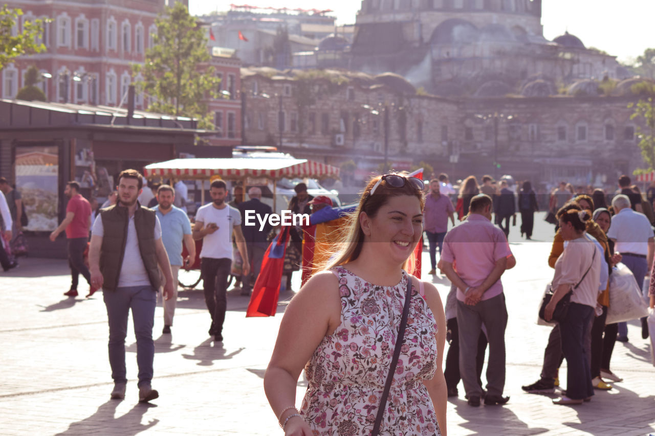 GROUP OF PEOPLE WALKING IN CITY