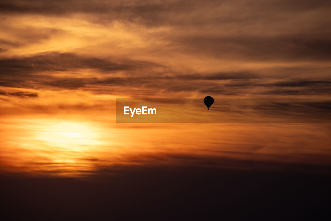 hot air balloons flying in sky during sunset
