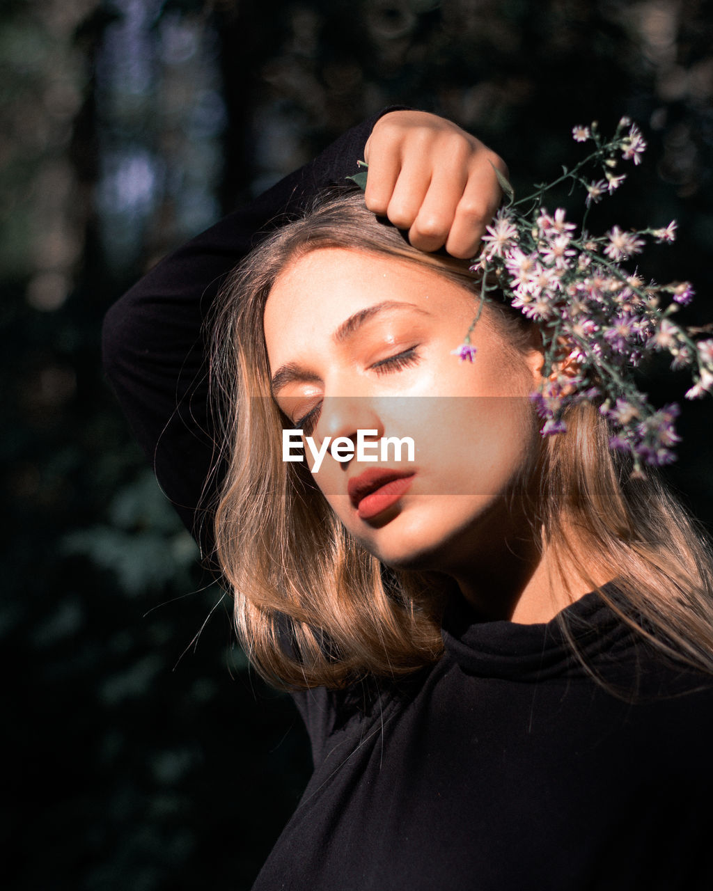 Beautiful young woman holding flower