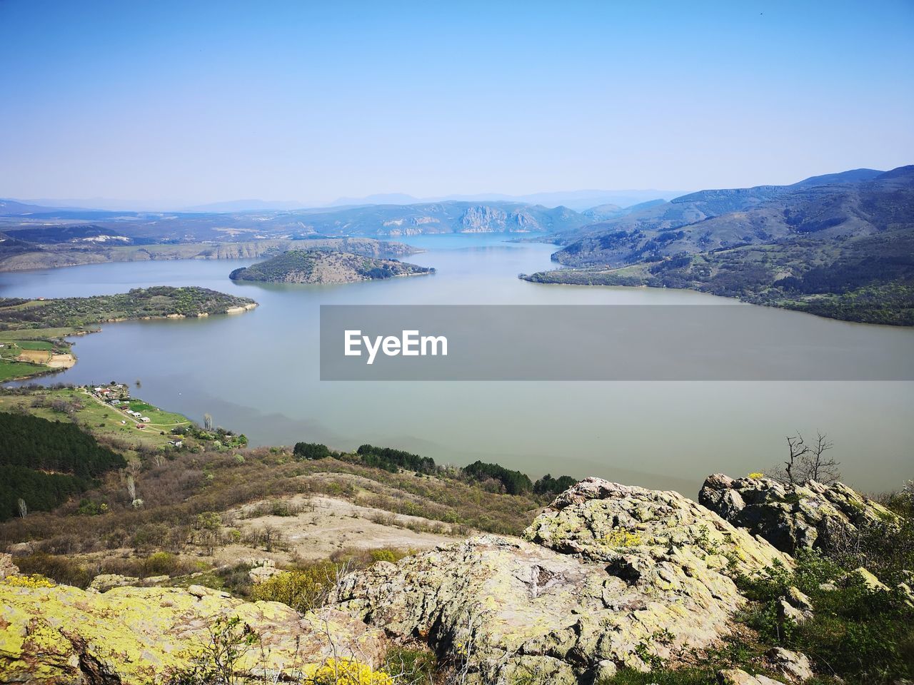 High angle view of lake and mountains against sky