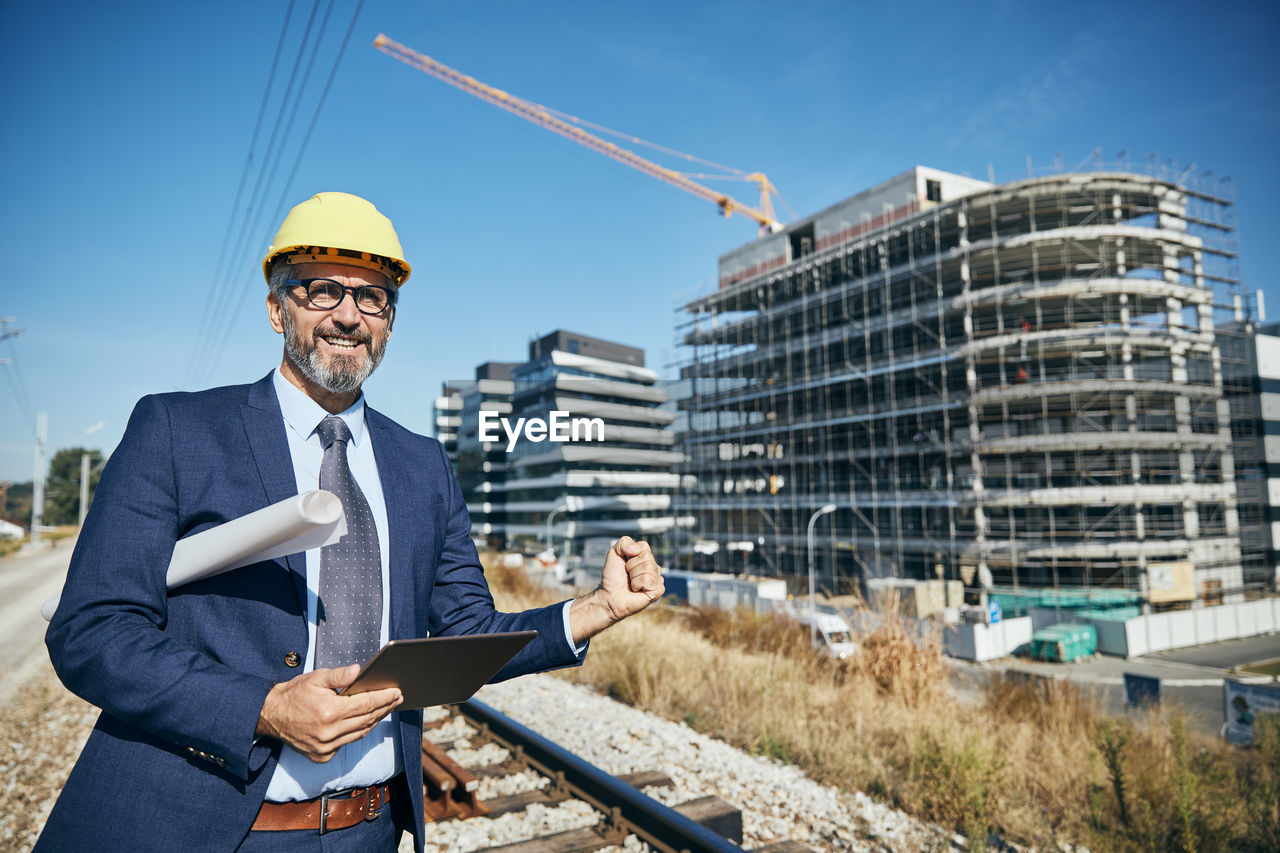 Engineer holding digital tablet at construction site