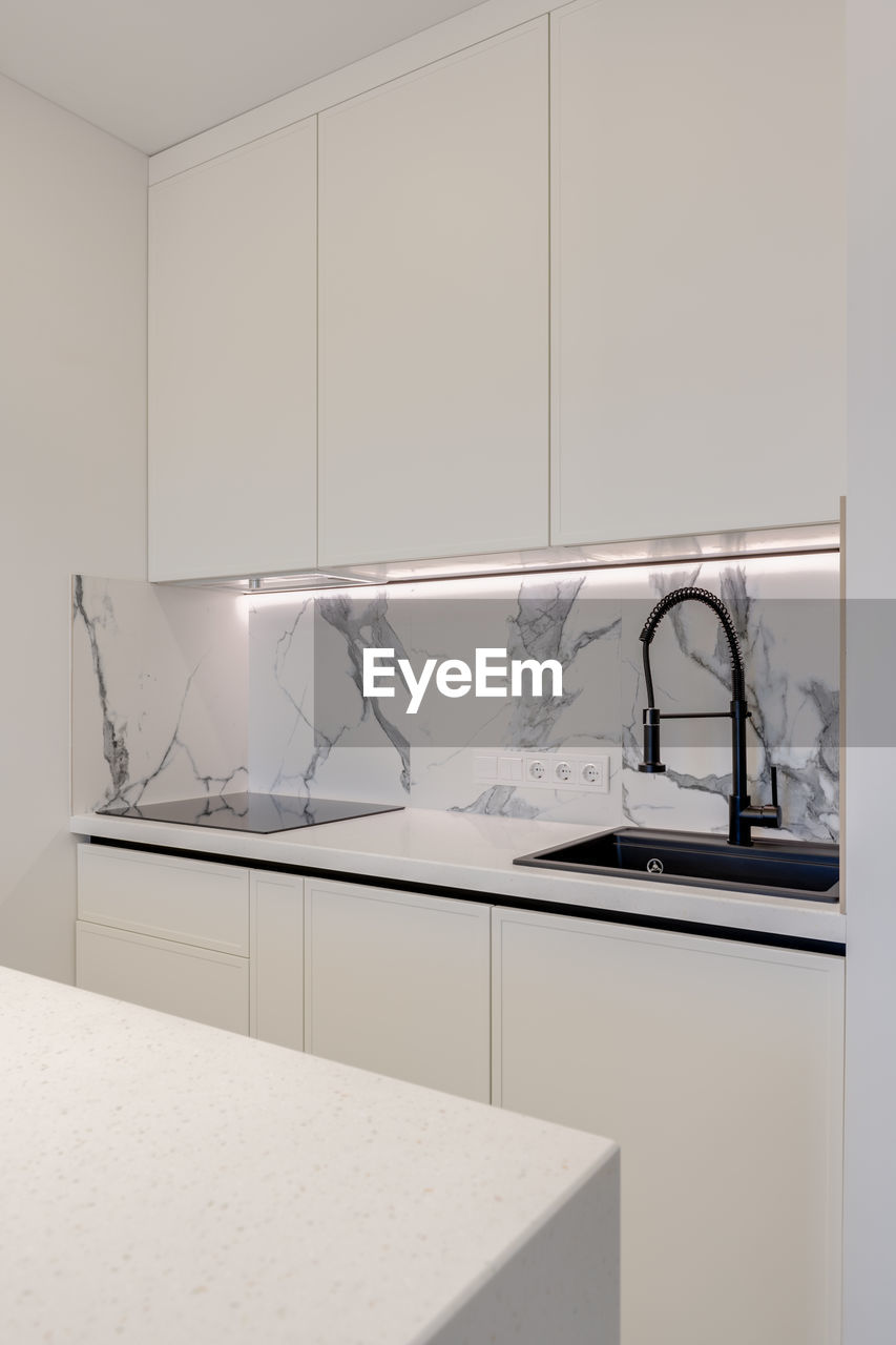 home, indoors, home interior, domestic room, sink, room, no people, furniture, interior design, household equipment, luxury, domestic kitchen, home showcase interior, architecture, floor, wealth, kitchen, white, tap, faucet, cabinetry, plumbing fixture, kitchen counter, domestic life, elegance, built structure, cabinet, lifestyles
