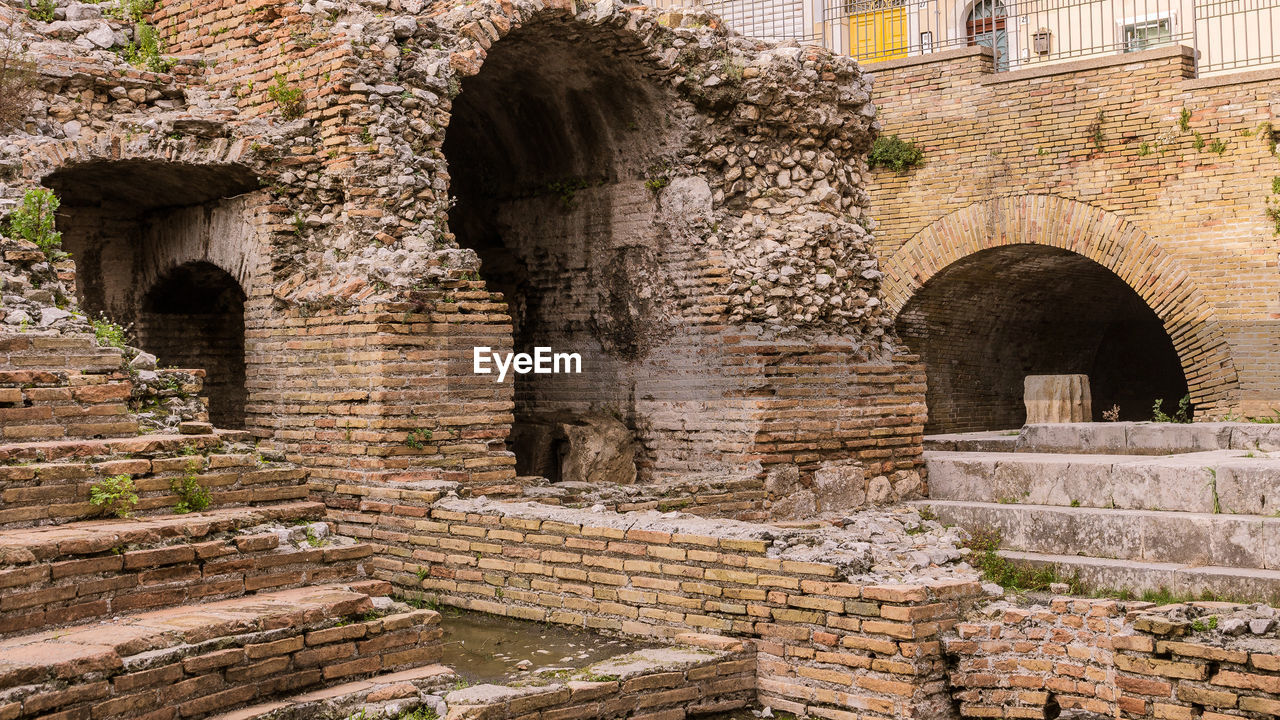 A detail of the ruins of odeon, the ancient greek theater of taormina, in sicily, landscape cut.