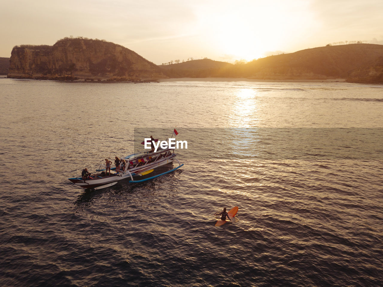 Aerial view of surfers and boat in the ocean, lombok, indonesia