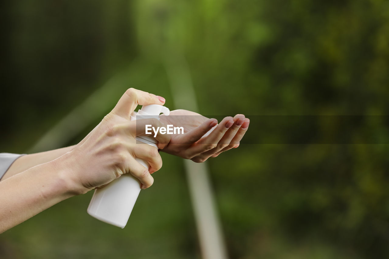 cropped hand of woman holding nail polish