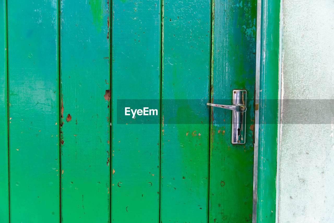 FULL FRAME SHOT OF CLOSED GREEN DOOR