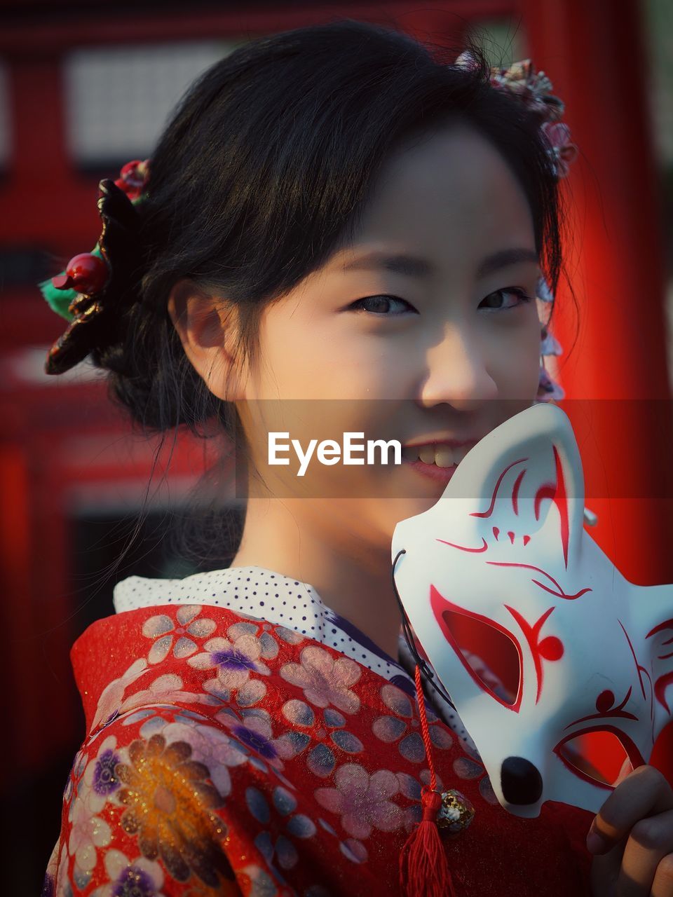 Smiling teenage girl wearing kimono outdoors