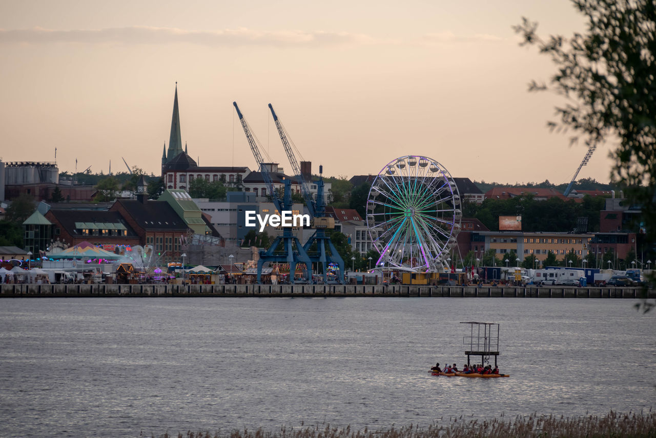 SCENIC VIEW OF FERRIS WHEEL AGAINST SKY AT SUNSET