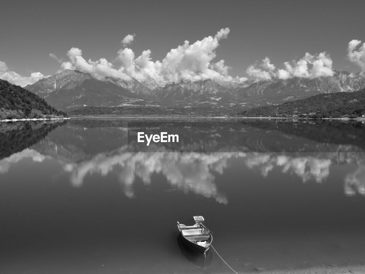 High angle view of boat moored in lake against cloudy sky