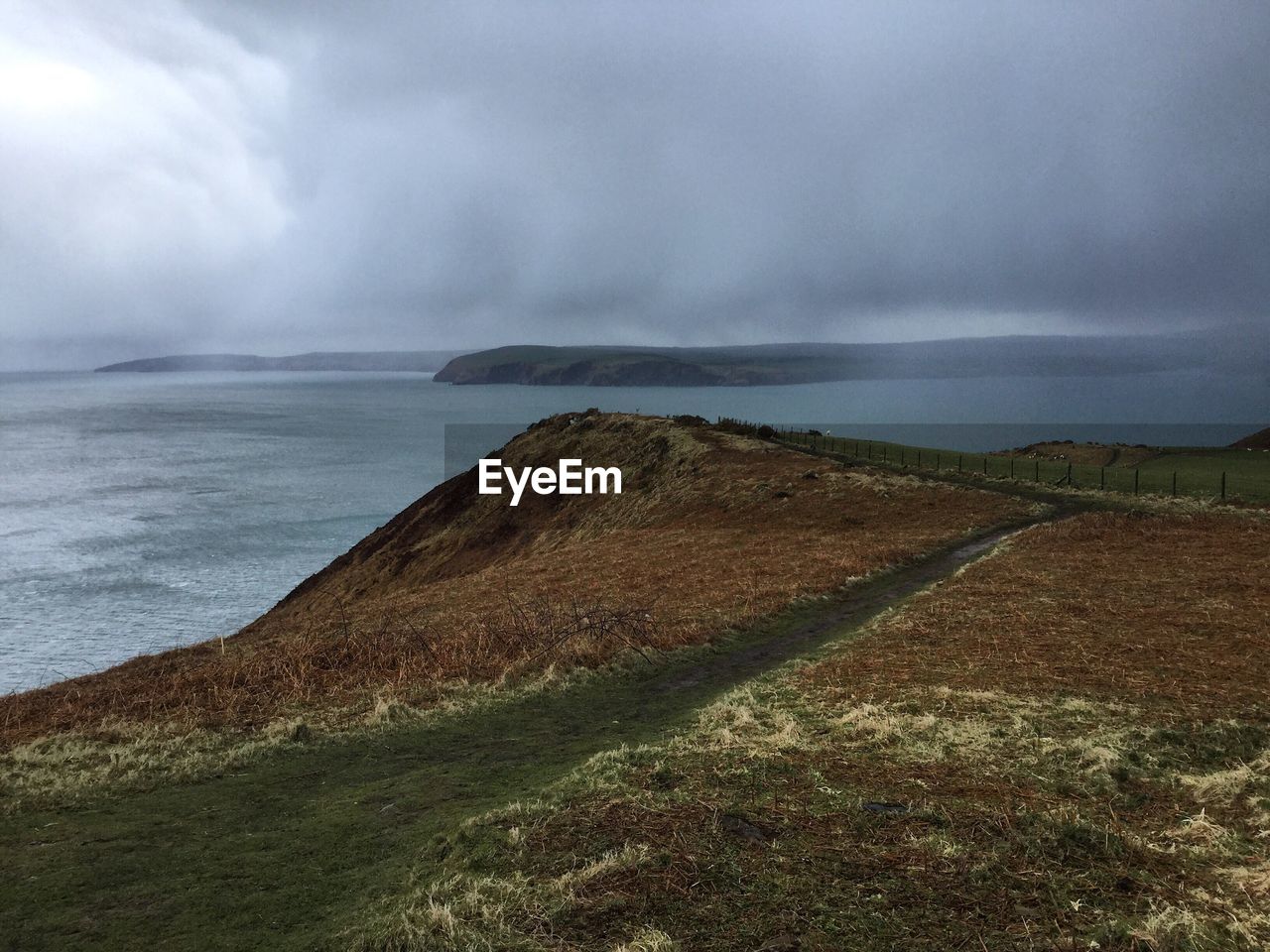 Scenic view of sea against cloudy sky