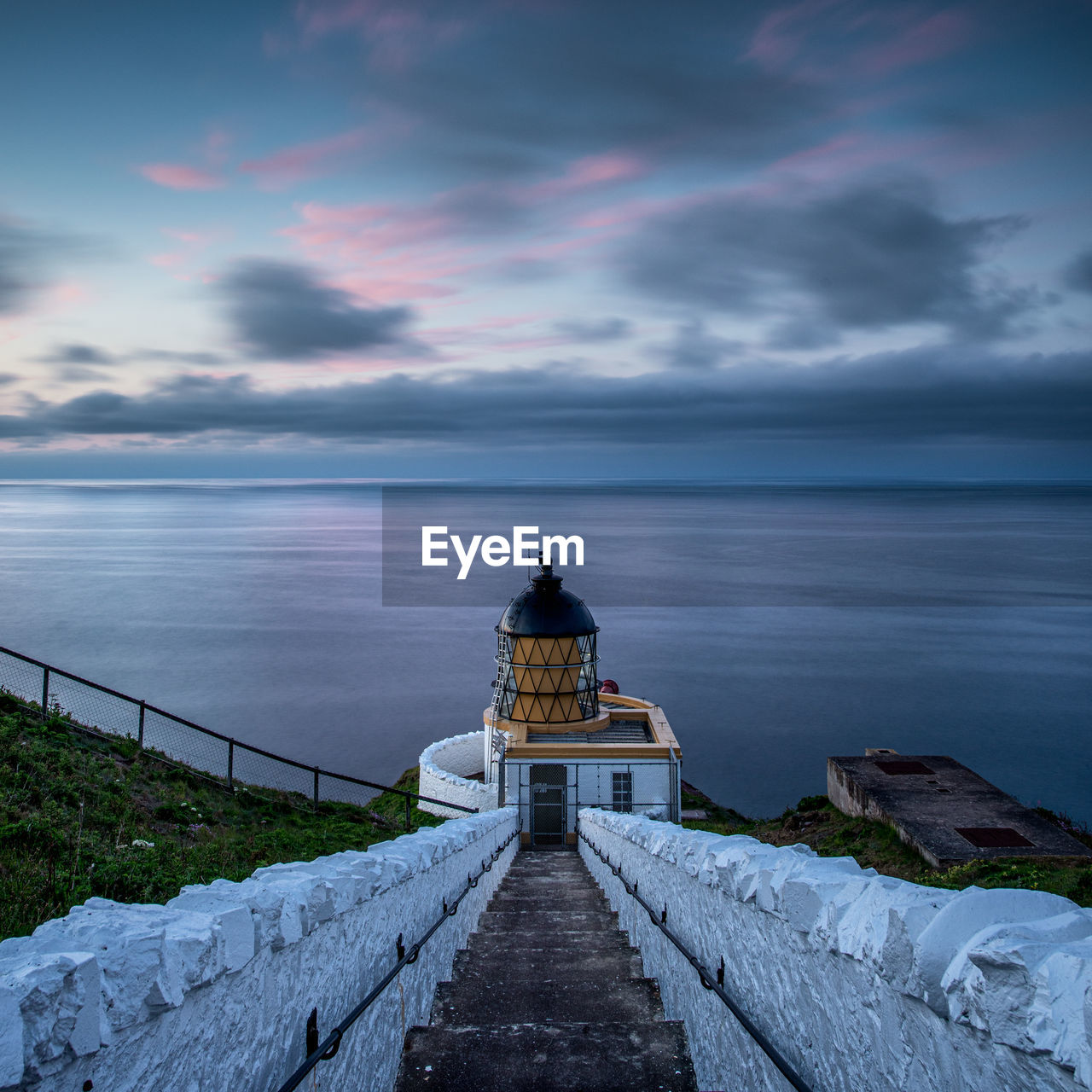 St abbs head lighthouse at sunset by the village of st abbs in berwickshire, scotland