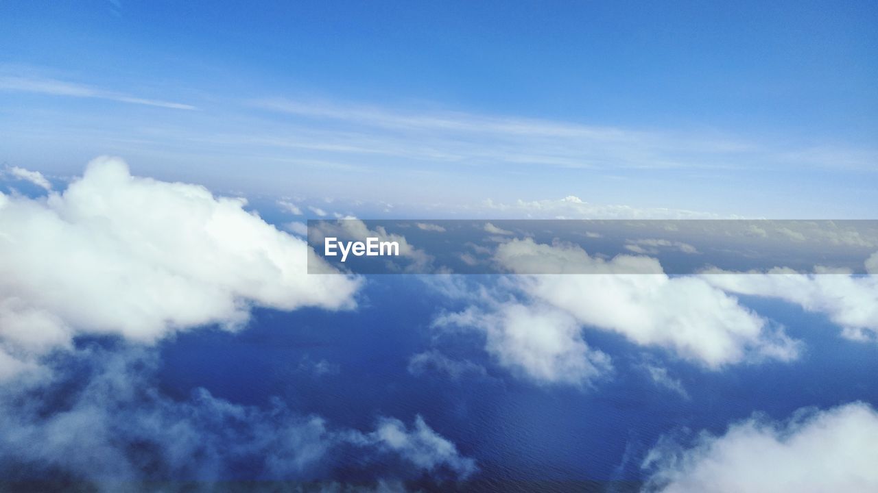 LOW ANGLE VIEW OF CLOUDS AGAINST BLUE SKY