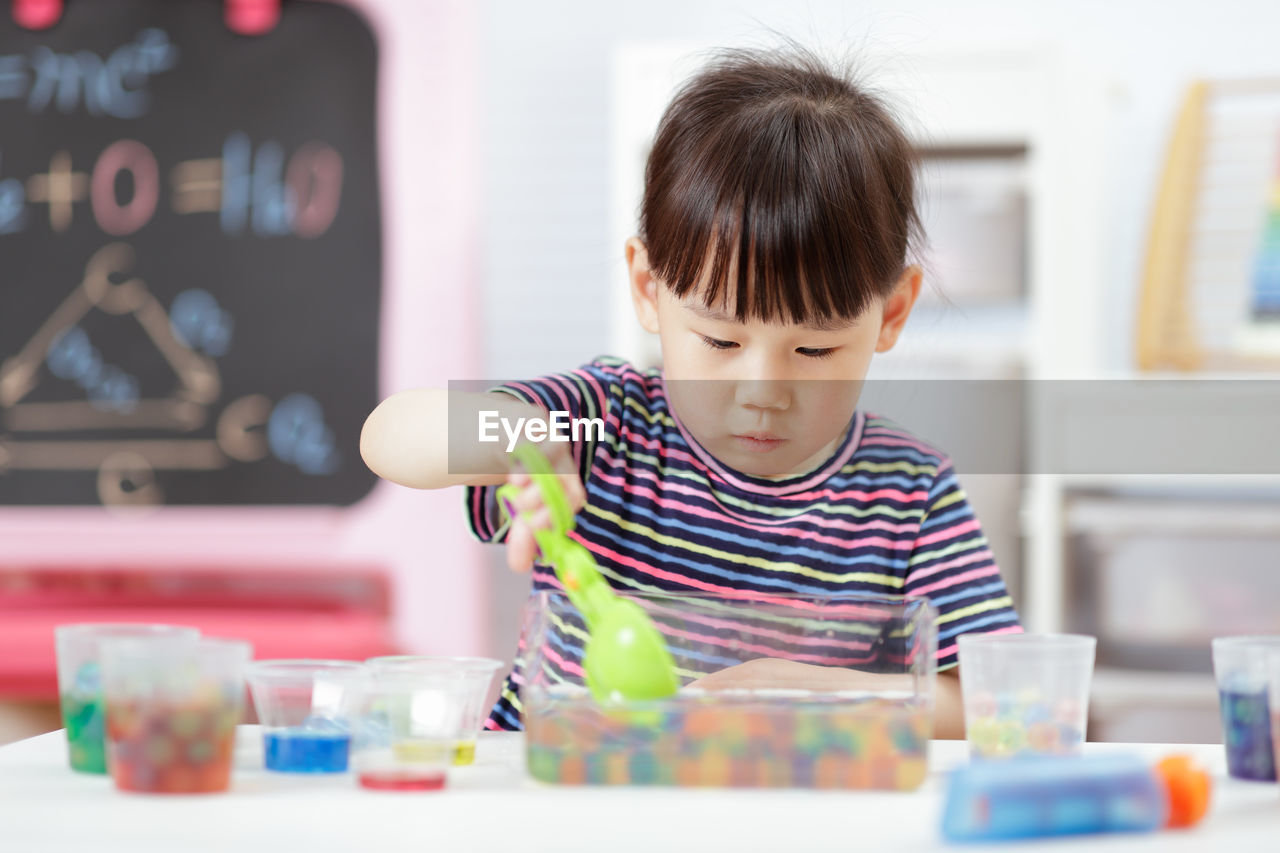 Young girl play science experiments for homeschooling