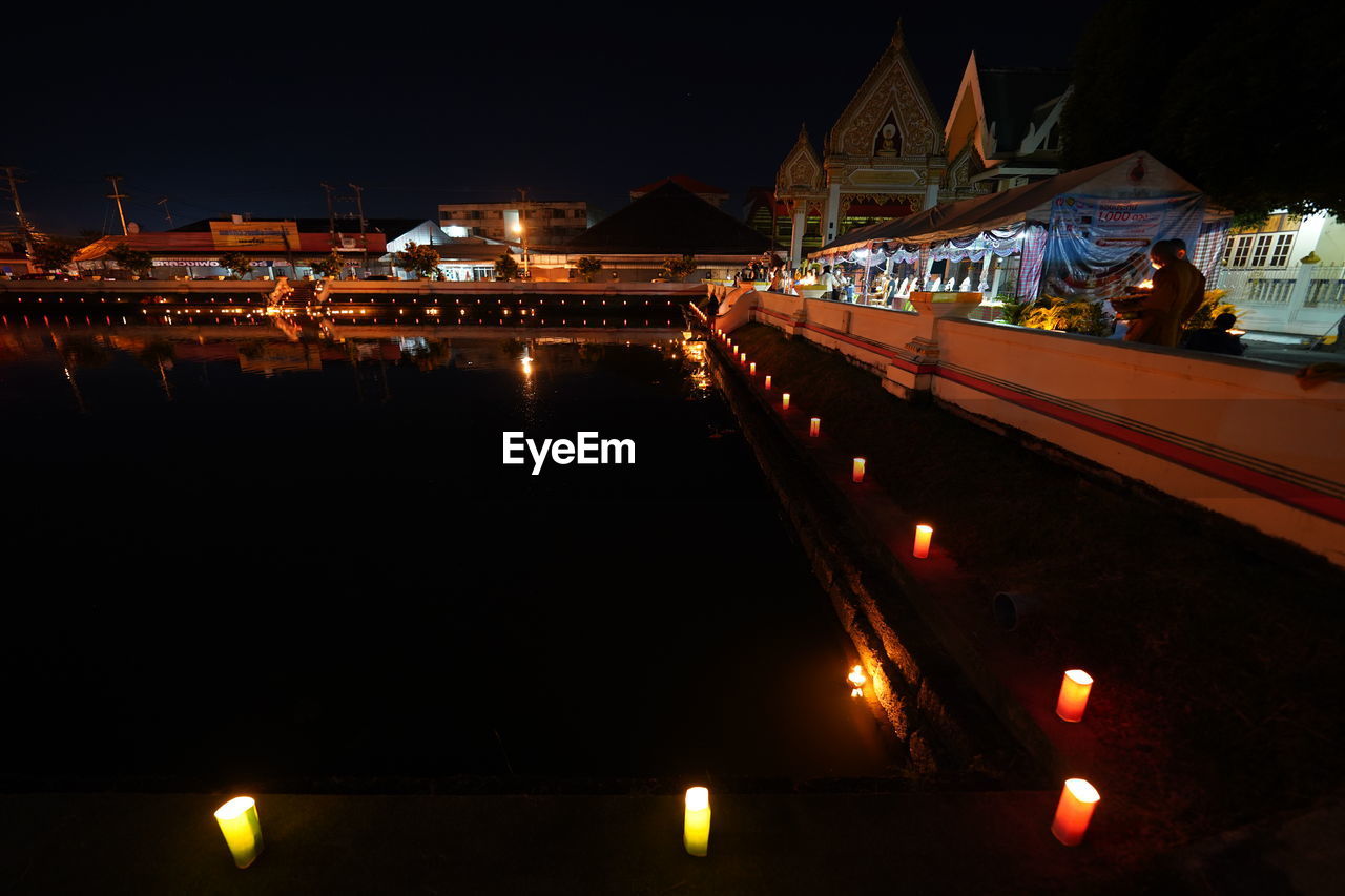 ILLUMINATED CITY BUILDINGS AT NIGHT