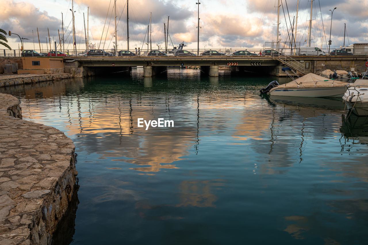 Sailboats moored in harbor