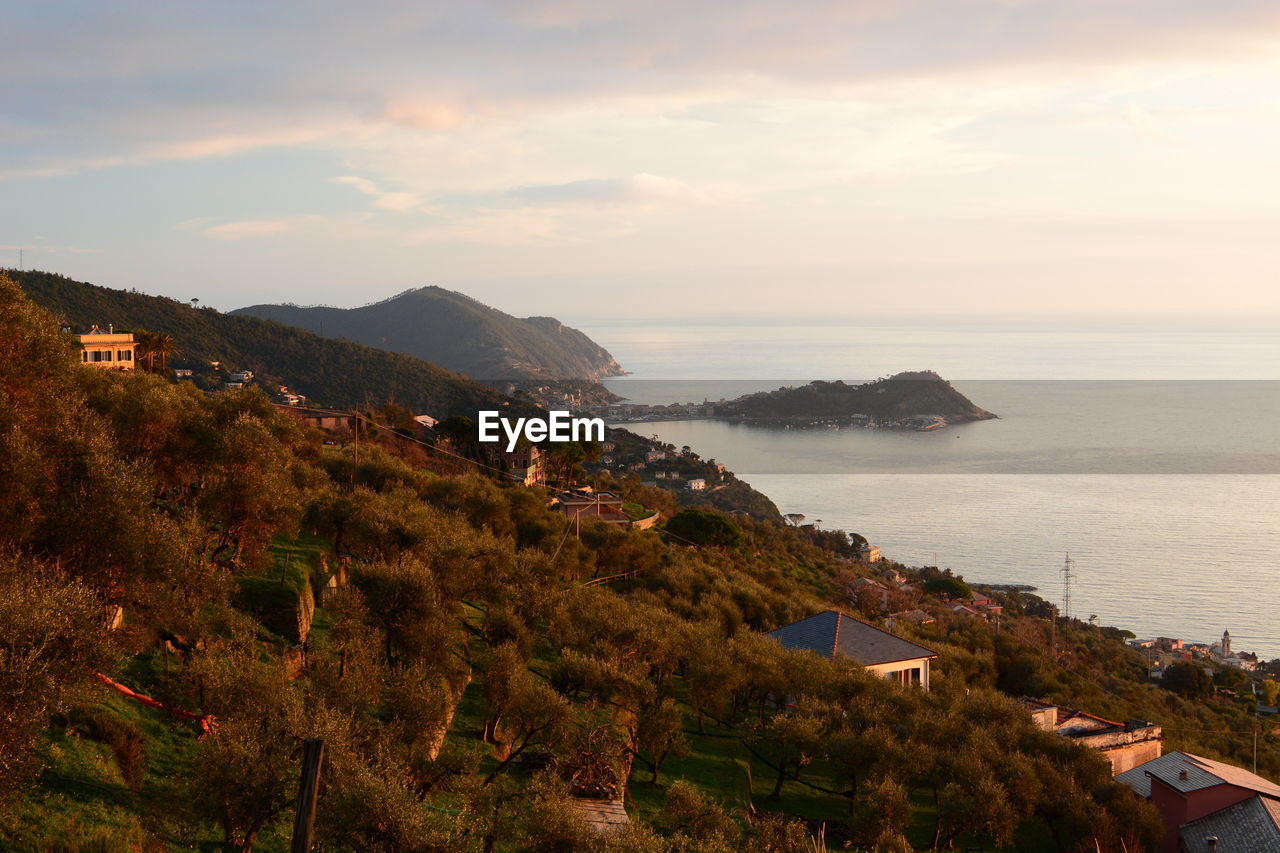 High angle view of townscape by sea against sky