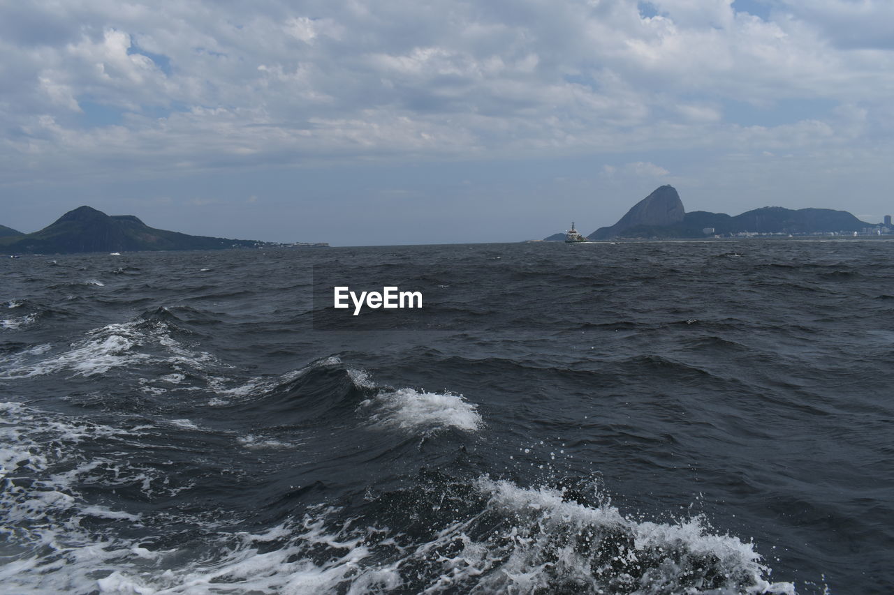 SCENIC VIEW OF SEA AND ROCKS AGAINST SKY