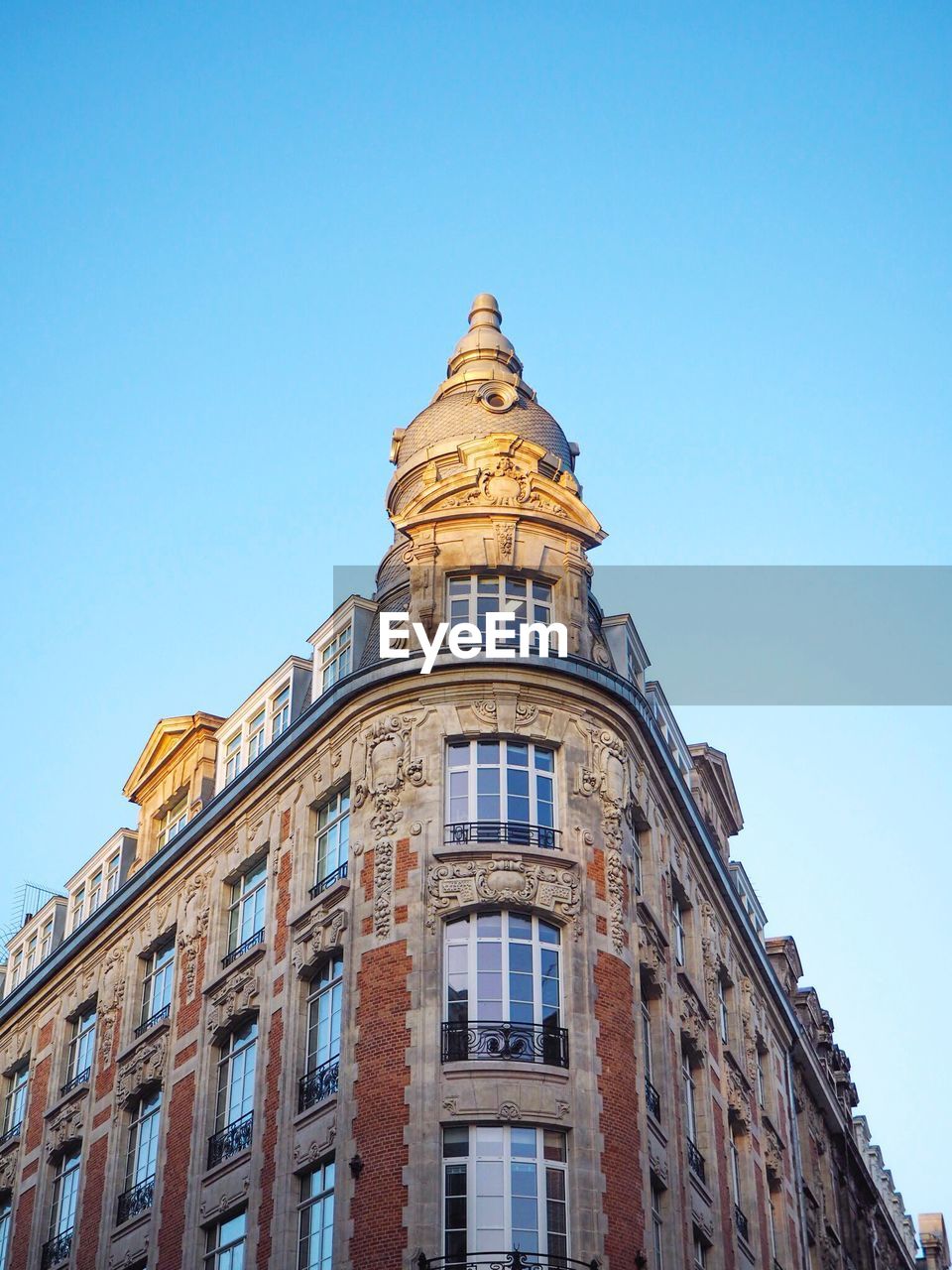 Low angle view of building against clear blue sky