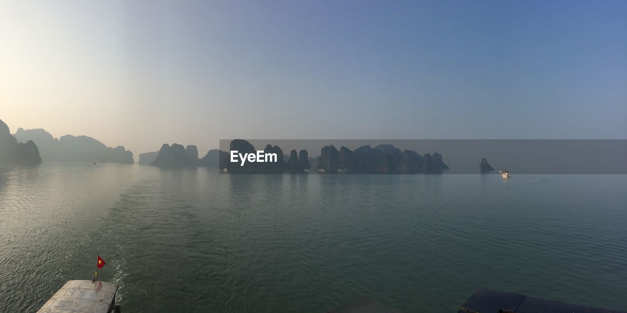 Rocks in sea against sky