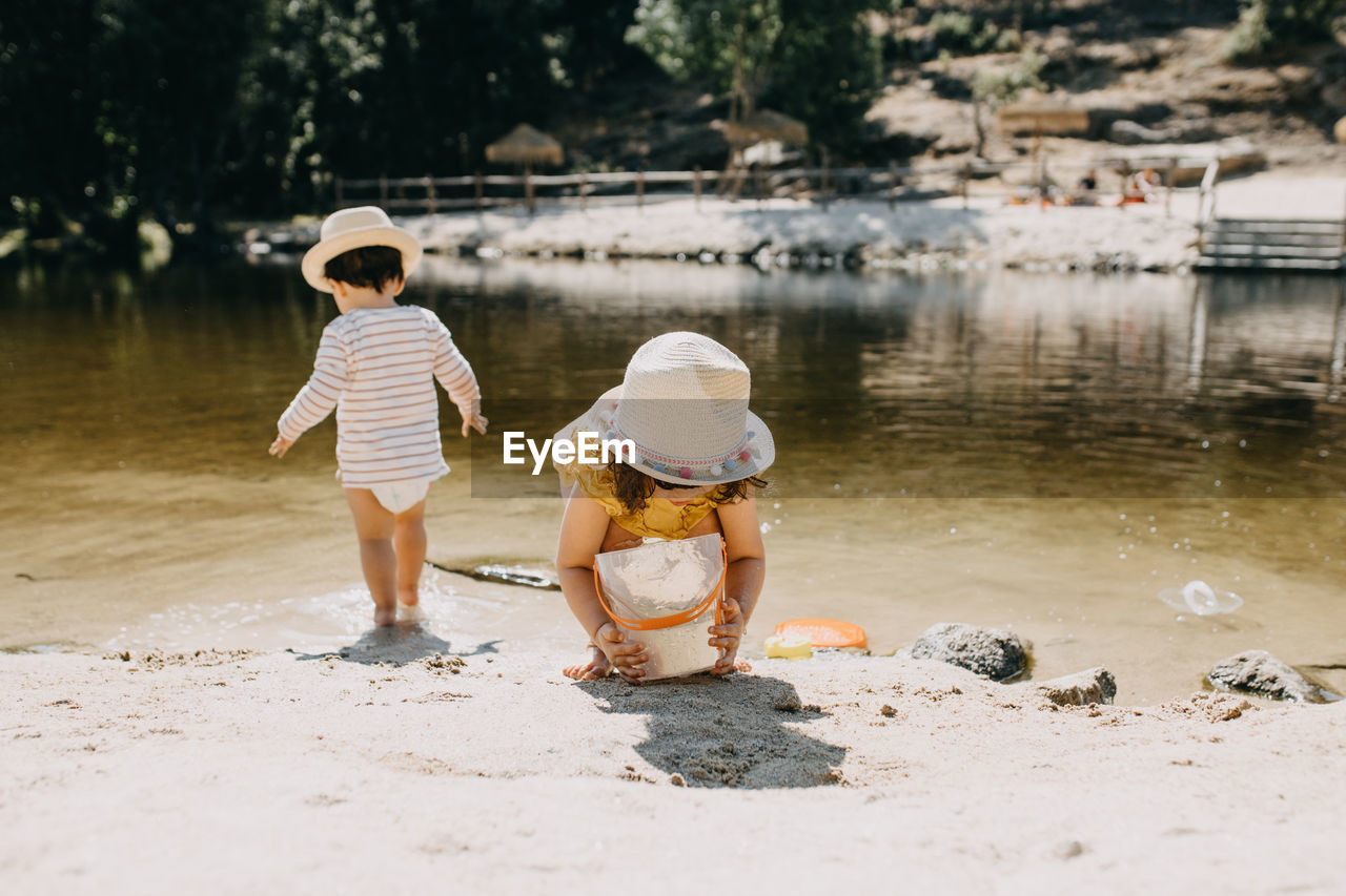 Brother and sister playing in the river