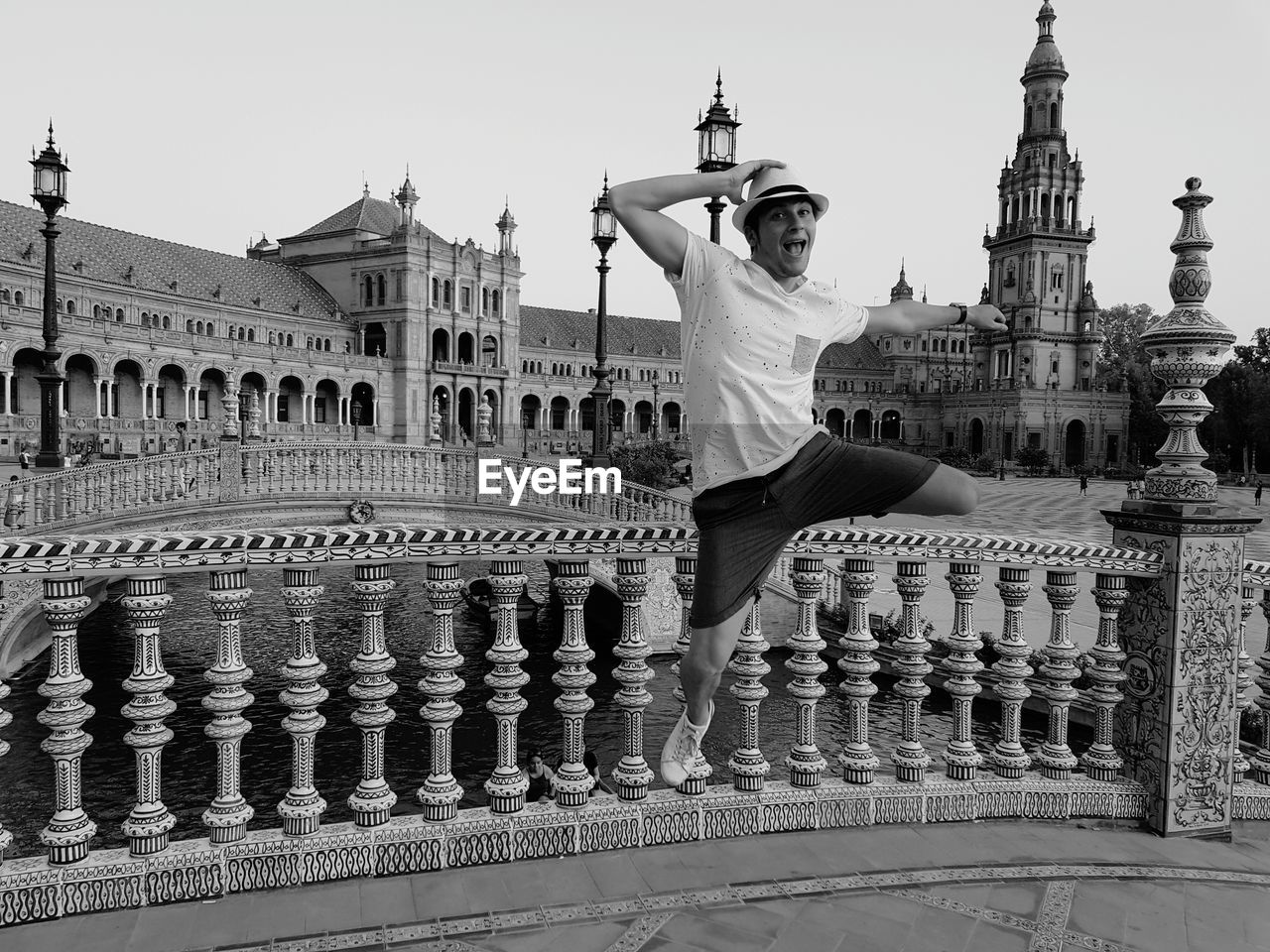 Portrait of cheerful young man jumping in city