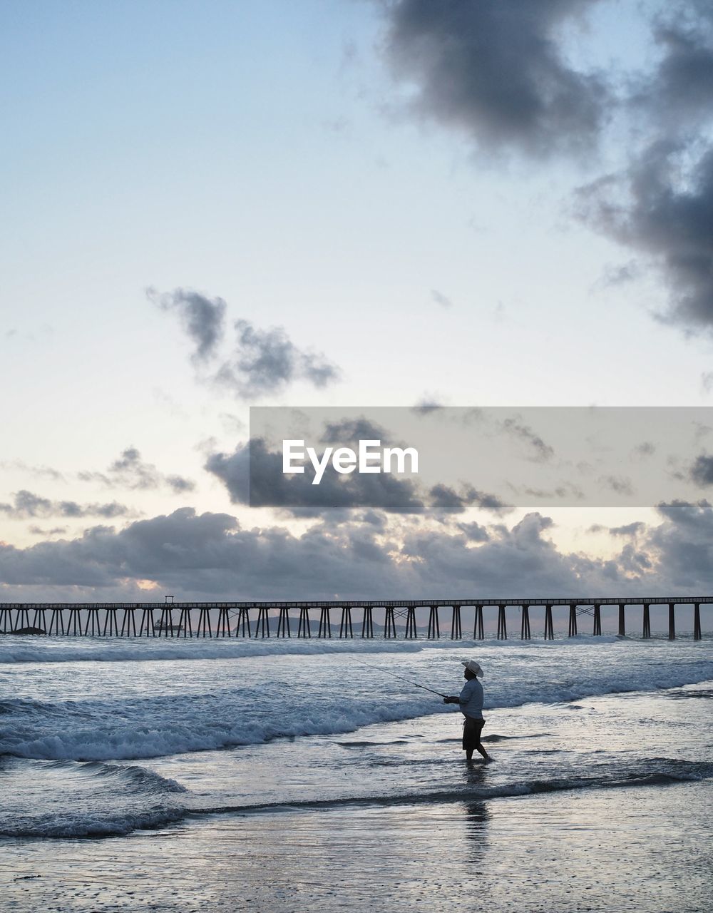 View of man fishing at beach