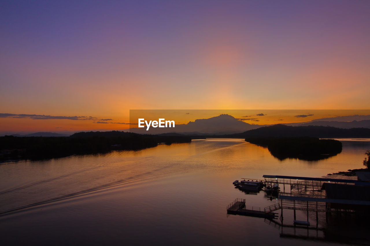 Scenic view of lake against sky during sunset