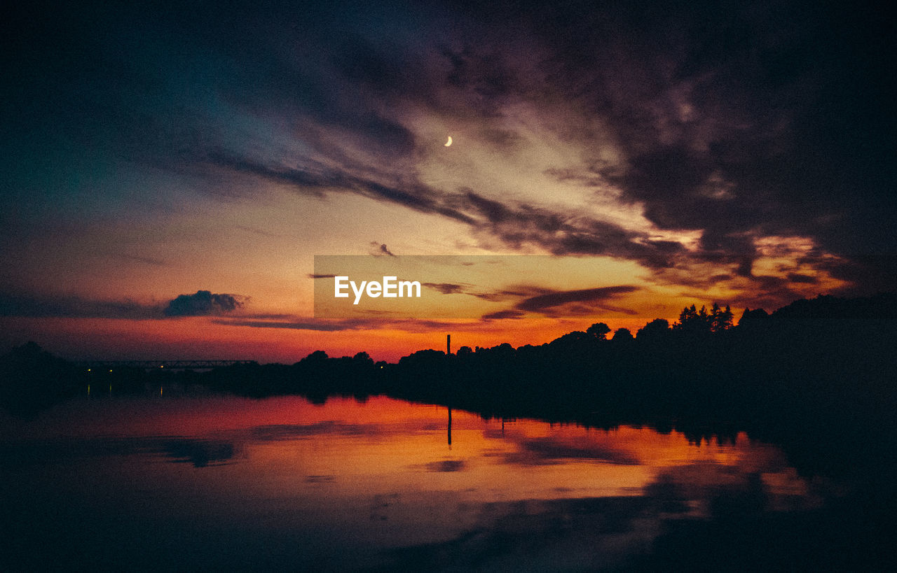 Scenic view of lake against romantic sky at sunset