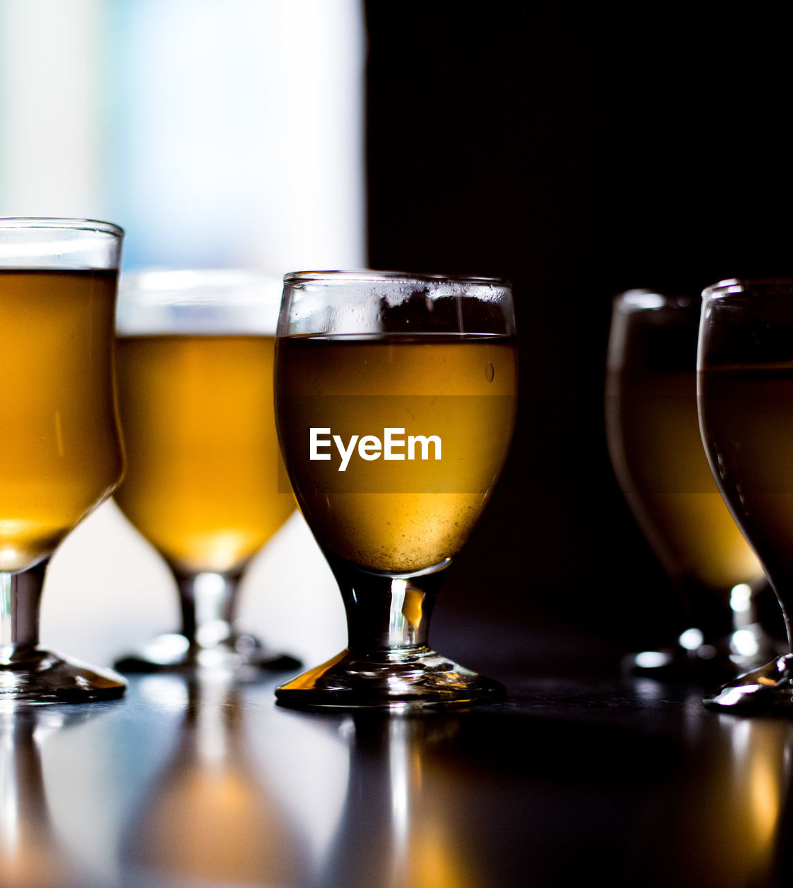 CLOSE-UP OF BEER GLASS ON TABLE WITH BAR